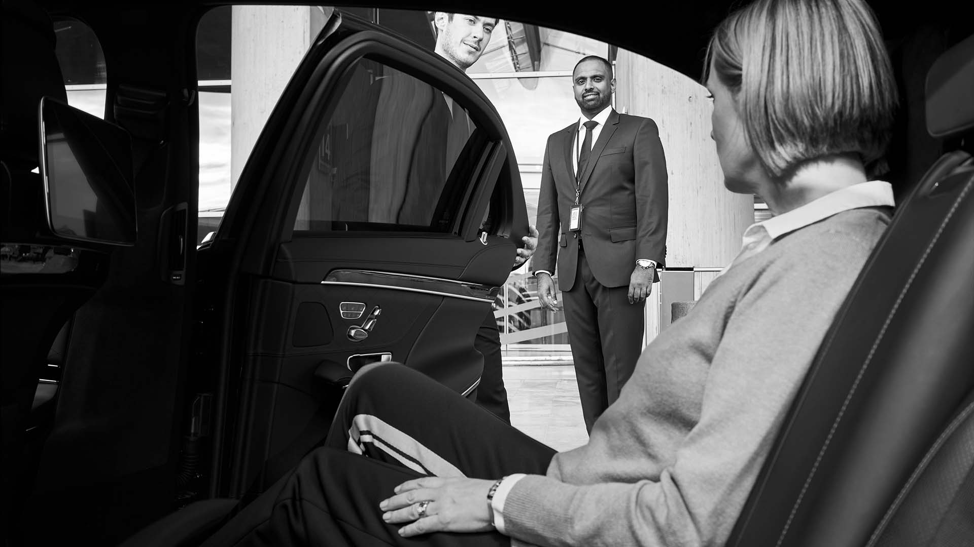 Chauffeur opening a luxury car door